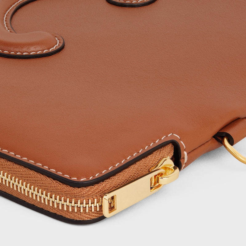 petite pochette avec bandouliÈre cuir triomphe en cuir de veau lisse